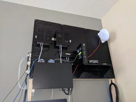 Apr 2018. The same two C2750 servers, now hung on a Wall Control metal pegboard with the network gear and a UniFi access point.